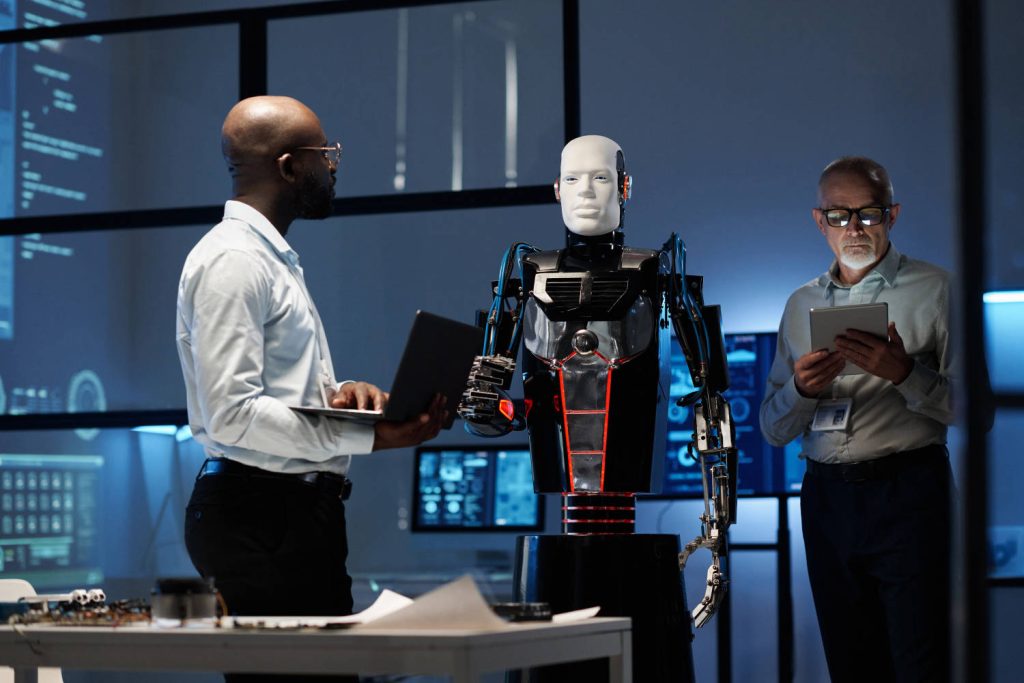 Engineers programming a robot